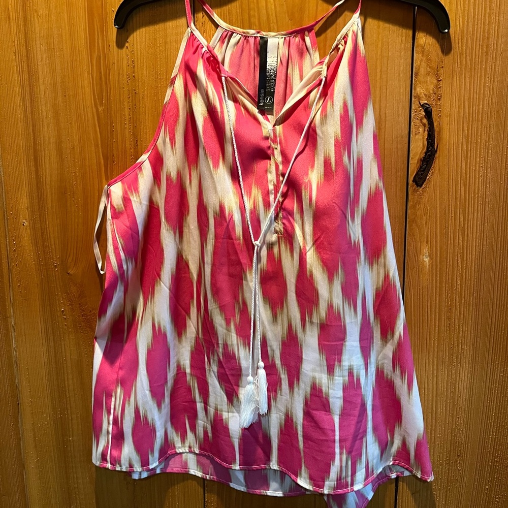 Sleeveless pink and white blouse with hints of gold.